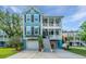 Two-story home with double porches, a two-car garage, and flower planters in front at 3711 Tip Ln, Mount Pleasant, SC 29466