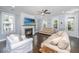 Living room features a fireplace, hardwood floors, and natural light with bright windows at 3711 Tip Ln, Mount Pleasant, SC 29466