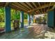 Covered outdoor patio featuring a built-in grill and serene backyard views at 3711 Tip Ln, Mount Pleasant, SC 29466