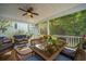 Relaxing screened porch with ceiling fan, dining table, and comfortable seating at 3711 Tip Ln, Mount Pleasant, SC 29466