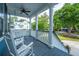 Inviting covered front porch with ceiling fan, white rocking chairs, and neighborhood views at 3711 Tip Ln, Mount Pleasant, SC 29466