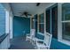 Relaxing front porch with rocking chairs, ceiling fan, and exterior lighting with blue siding at 3711 Tip Ln, Mount Pleasant, SC 29466