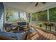 Cozy screened porch with wicker furniture, perfect for outdoor enjoyment at 3711 Tip Ln, Mount Pleasant, SC 29466