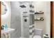 Modern bathroom features large shower, marble wall panels and floating shelves at 3935 Walnut St, North Charleston, SC 29405
