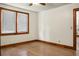 Empty bedroom featuring hardwood floors, a ceiling fan, neutral paint, and natural light from two windows at 3935 Walnut St, North Charleston, SC 29405