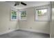 Bedroom featuring neutral paint, carpet, a ceiling fan and two large windows offering exterior views at 3935 Walnut St, North Charleston, SC 29405