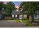 Exterior view of a cozy home featuring lush landscaping and a gravel driveway at 3935 Walnut St, North Charleston, SC 29405