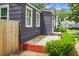 Charming home exterior featuring stone and brick accents with a wood fence for added privacy at 3935 Walnut St, North Charleston, SC 29405