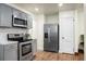 Bright kitchen offers stainless appliances, gray cabinetry, and wood-look floors at 3935 Walnut St, North Charleston, SC 29405
