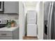 Laundry area featuring a stackable washer and dryer conveniently located next to kitchen appliances at 3935 Walnut St, North Charleston, SC 29405