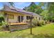 View of a home's backyard and deck, with mature trees and lush greenery at 4 Garth Dr, Charleston, SC 29414