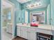 Blue bathroom with a double sink vanity and separate toilet and shower area at 4 Garth Dr, Charleston, SC 29414