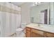 Simple bathroom with a shower-tub combo, standard toilet, and wood-look vanity at 4 Garth Dr, Charleston, SC 29414