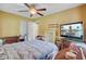Bedroom featuring yellow walls, carpet floors, ceiling fan and adjacent TV at 4 Garth Dr, Charleston, SC 29414