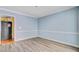 Empty dining room with light blue walls, white trim, and wood-look laminate flooring at 4 Garth Dr, Charleston, SC 29414
