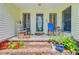 Inviting front porch with brick steps, potted plants, and rocking chairs creating a cozy outdoor space at 4 Garth Dr, Charleston, SC 29414
