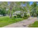 Attractive house with a sprawling lawn and mature shade trees, enhanced by solar panels atop the roof at 4 Garth Dr, Charleston, SC 29414