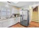 This kitchen features stainless steel appliances, white cabinetry, and hardwood floors at 4 Garth Dr, Charleston, SC 29414