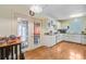 Well-lit kitchen with hardwood floors, white cabinets, and a door leading to an outdoor space at 4 Garth Dr, Charleston, SC 29414