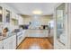 Bright kitchen features white cabinetry, stainless steel appliances, and hardwood floors at 4 Garth Dr, Charleston, SC 29414