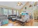 Bright living room featuring hardwood floors, an aquarium, and a spiral staircase leading to the upper level at 4 Garth Dr, Charleston, SC 29414