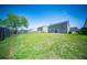 A spacious, fenced backyard featuring a lush lawn and mature tree, perfect for outdoor activities and relaxation at 414 Dovetail Cir, Summerville, SC 29483