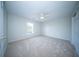 Carpeted bedroom with ceiling fan, window, and open closet door at 414 Dovetail Cir, Summerville, SC 29483