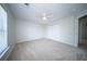 Neutral carpeted bedroom with ceiling fan, bright window and closet at 414 Dovetail Cir, Summerville, SC 29483