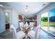 Dining room features a glass table with white chairs and a sliding glass door to the backyard at 414 Dovetail Cir, Summerville, SC 29483