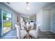Dining area with glass table and access to backyard, flowing into the living room with fireplace at 414 Dovetail Cir, Summerville, SC 29483