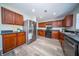 Spacious kitchen features stainless steel appliances, dark countertops, and ample cherry cabinets at 414 Dovetail Cir, Summerville, SC 29483