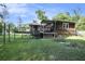 Back of house view with hot tub and ample greenery at 417 Dennis Ave, Moncks Corner, SC 29461
