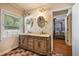 Well-lit bathroom featuring a double sink vanity with decorative mirrors, complemented by tiled floors at 417 Dennis Ave, Moncks Corner, SC 29461