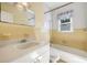 Classic bathroom with yellow tiling, single sink vanity, and a shower-tub combination at 417 Dennis Ave, Moncks Corner, SC 29461