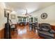 Charming dining area with hardwood floors, piano, and a table set for a meal at 417 Dennis Ave, Moncks Corner, SC 29461