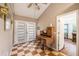 Bright entryway with vintage desk, double glass doors, and unique checkerboard flooring at 417 Dennis Ave, Moncks Corner, SC 29461