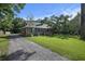 A charming house with a gravel driveway, well-maintained lawn, and mature trees at 417 Dennis Ave, Moncks Corner, SC 29461