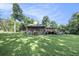 Expansive front yard showcasing a quaint home with a large porch and a lush lawn at 417 Dennis Ave, Moncks Corner, SC 29461