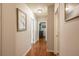Hallway features hardwood floors, neutral walls with framed artwork, and multiple doorways at 417 Dennis Ave, Moncks Corner, SC 29461