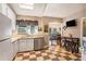 Kitchen featuring checkerboard floors, white appliances, a sink and view into the dining room at 417 Dennis Ave, Moncks Corner, SC 29461