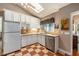 Bright kitchen featuring checkerboard floors, white cabinets, and skylight for ample natural light at 417 Dennis Ave, Moncks Corner, SC 29461