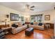 Inviting living room with plush sofas, stylish decor, and gleaming hardwood floors at 417 Dennis Ave, Moncks Corner, SC 29461