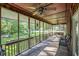 Covered porch featuring ceiling fans, chairs, and a swing, with views of the yard at 417 Dennis Ave, Moncks Corner, SC 29461
