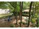 Aerial view of the backyard featuring an outdoor fire pit area and lush, green trees at 5032 Coral Reef Dr, Johns Island, SC 29455