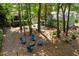 Aerial view of the outdoor fire pit area and lush, green backyard of this home at 5032 Coral Reef Dr, Johns Island, SC 29455