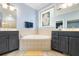 Bright bathroom featuring dual vanities and a corner tub for comfort and convenience at 5032 Coral Reef Dr, Johns Island, SC 29455