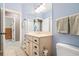 Bright bathroom with a light wood vanity, a large mirror, and soft blue walls at 5032 Coral Reef Dr, Johns Island, SC 29455
