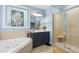 A bathroom features a shower, jetted tub, and serene decor, ideal for relaxation and rejuvenation at 5032 Coral Reef Dr, Johns Island, SC 29455