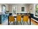 Dining room with wooden table and yellow upholstered chairs, large window, and stylish decor at 5032 Coral Reef Dr, Johns Island, SC 29455
