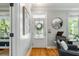 Bright entryway with hardwood floors, a round mirror, and a console table at 5032 Coral Reef Dr, Johns Island, SC 29455